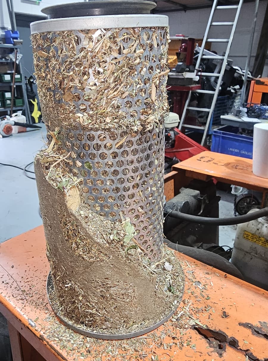 An air filter as it came off, packed solid. An engine like that is fighting for breath.