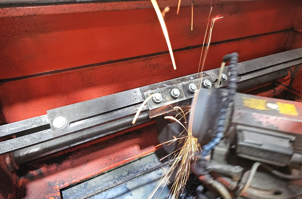 A chipper blade clamped on the bed of the Chippermaster, part-way through a pass.